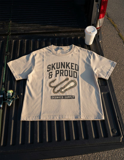 Skunked & Proud tee on the dock with fishing gear